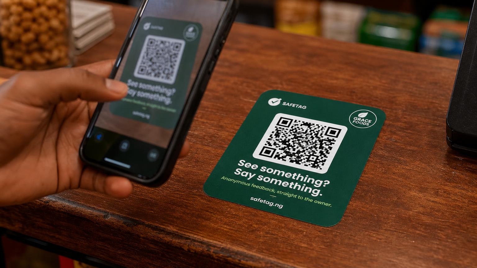Customer scanning a SafeTag feedback sticker on a counter